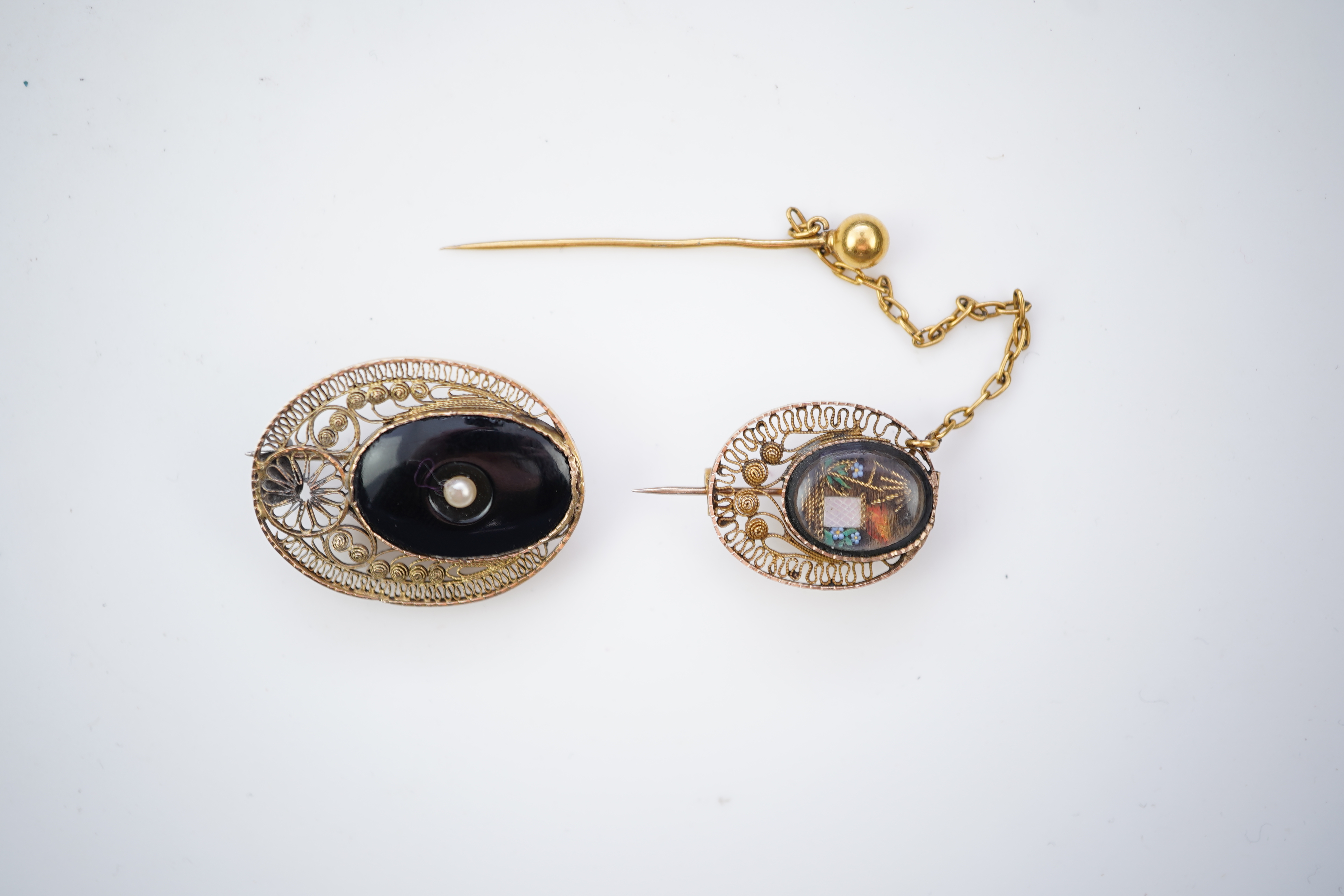 A collection of shell cameo brooches, comprising: a cameo depicting Bacchus, in a gold mount in the Archaeological Revival style, decorated with rope twist and a twisted knife wire border, length 4.4cm; together with sev